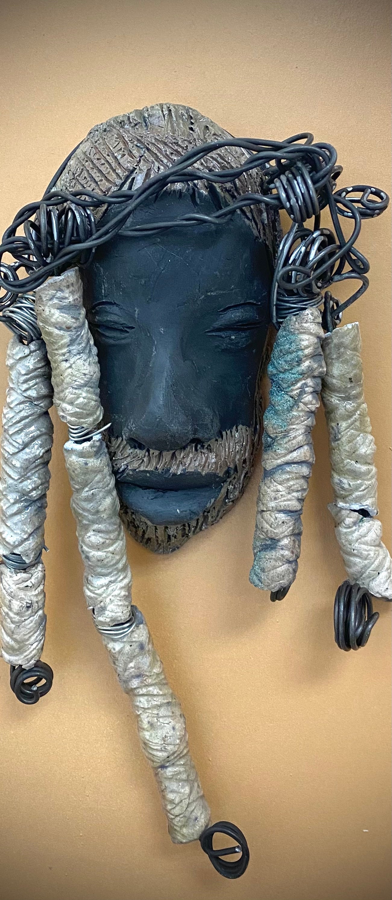 Meet Afumba! I started making art soon after seeing authentic African artwork at the Smithsonian Museum of African Art. I was in total awe. Afumba was inspired by my visit there.   Afumba is a wise and distinguished  bearded gentleman who has a smoky dark complexion. He is approximately 8" x 4" and weighs 10 ozs. Afumba has an aged hairstyle of 10 handmade textured off white clay dreadlocks along with twist of coiled 16 gauge wire.