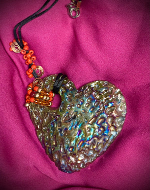  Have A Heart ! Each heart pendant is handmade with love! It is 3"x 3" and weighs approx. 3ozs. This pendant has a copper gold metallic raku glazes that renders a unique translucent  patina. The heart has a textured pattern . It holds a spiral of amber and red mini beads on a spiral copper wire. This pendant has a nice 12" black suede cord!