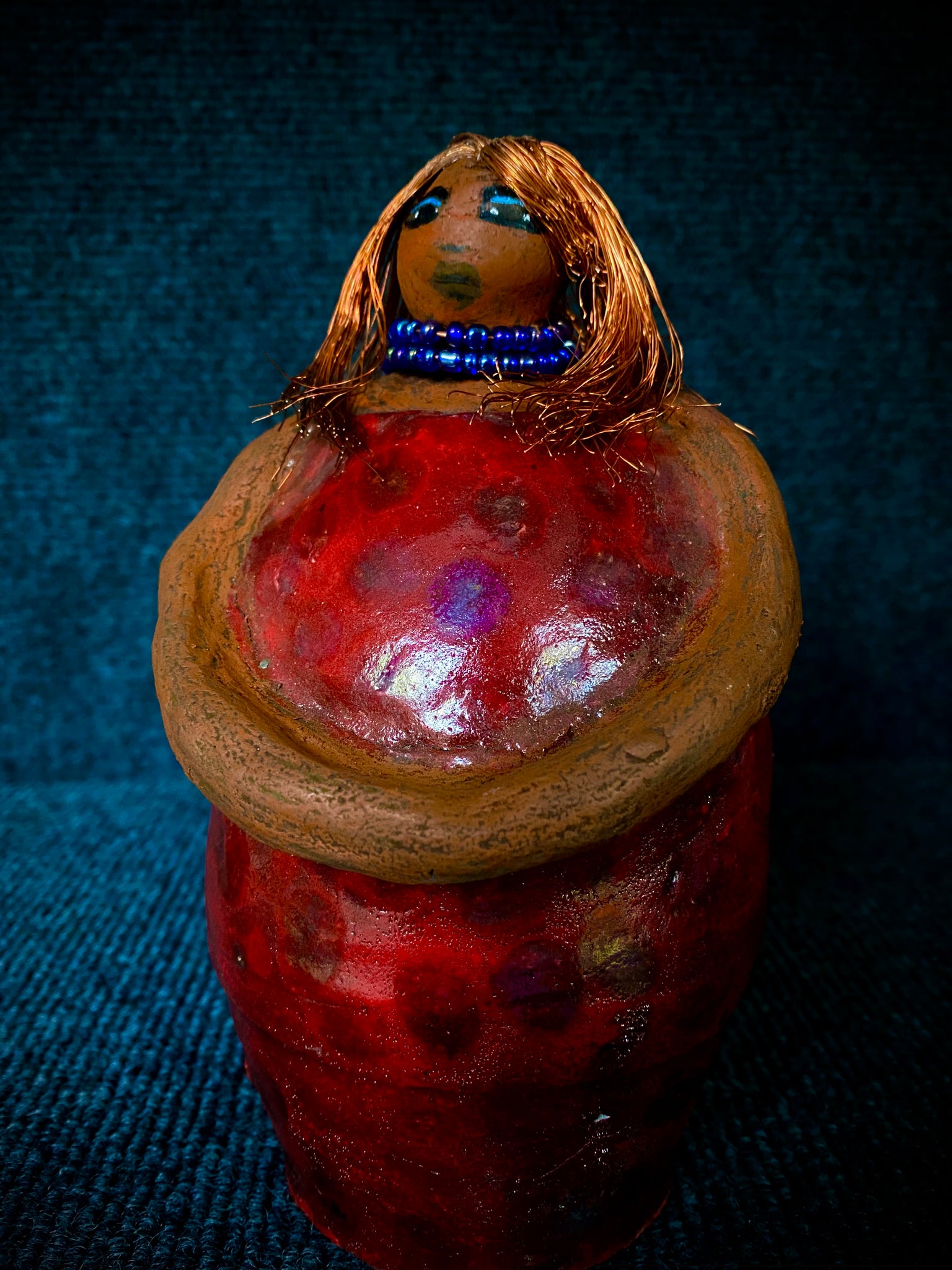 ﻿Meet Dora!  She is a big girl who loves to sing and has aspirations of becoming a  movie star.  Dora stands 7" x 4" x 4.5" and weighs  1.06 lbs.  She has a lovely honey brown complexion with lovely reddish brown lips.  Dora has a lovely gold spotted heart glazed dress.  She wears a beaded  dark blue necklace.  With eyes wide opened, Dora has hopes of finding a new home.   Dora has a twin sister name Cora.