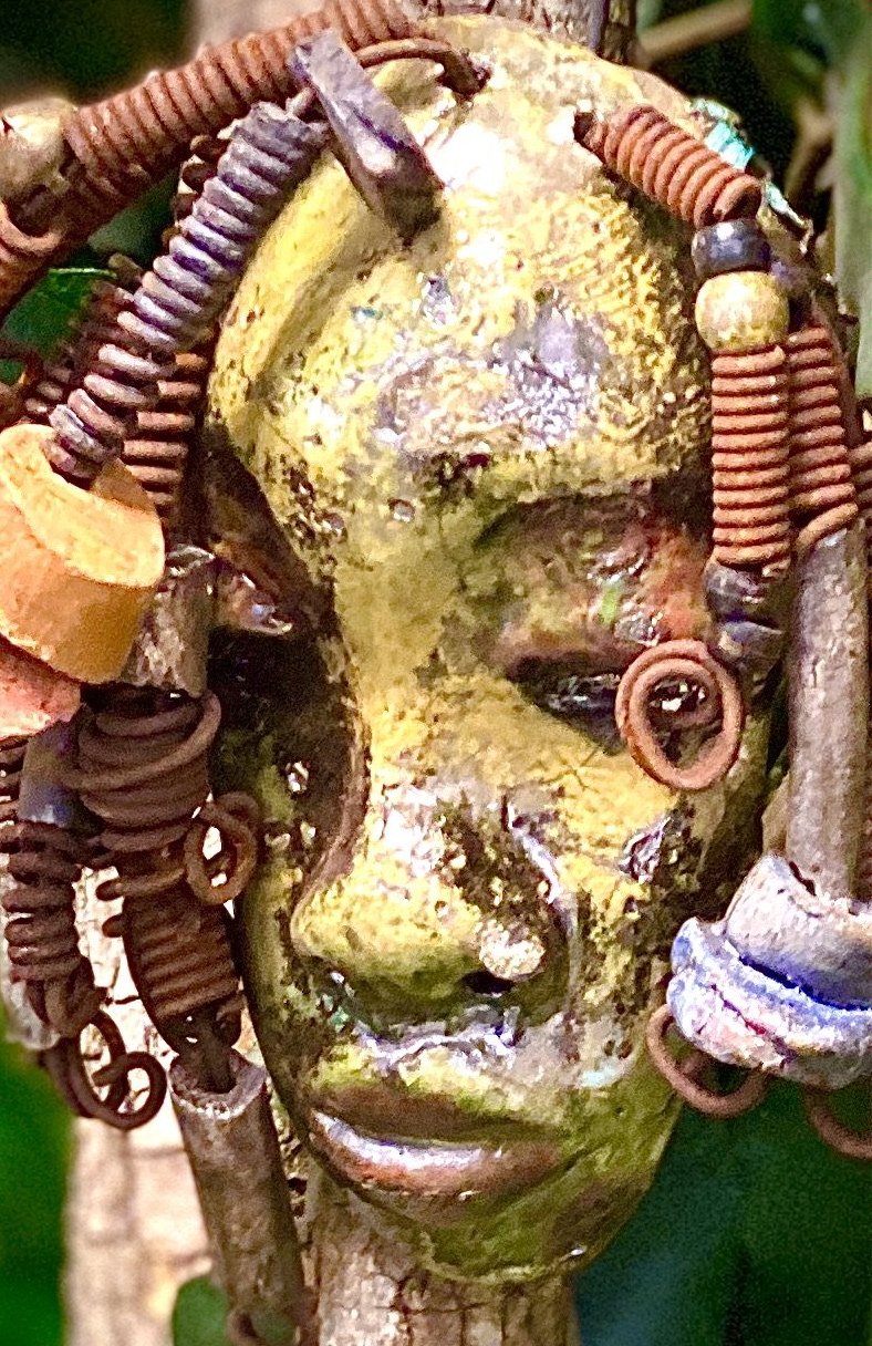 Araya has a yellow green complexion and dark red lips! She is 3”x 5”" and weighs 9 ozs. Araya  has over 5 handmade raku fired beads. She has over 20 feet of coiled 16 gauge wire hair.