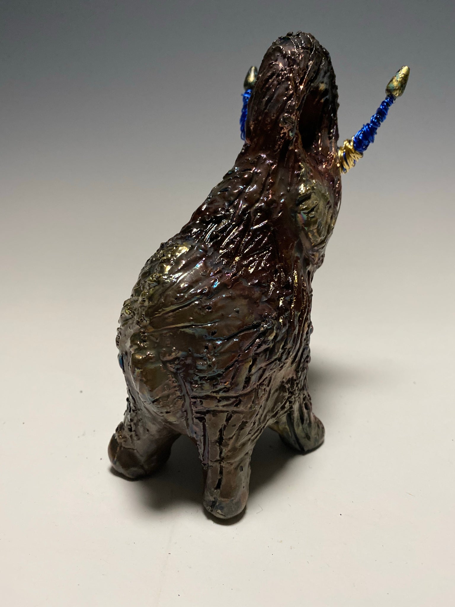 Raku Elephant Have you HERD!!!!!!  Just one of these lovely Raku Fired Elephant will make an excellent gift for your  friend, sorority or for your home’ special place centerpiece.   6" x 4" x 4" 1 lbs Beaded tusk with blue and gold wire Beautiful  colorful metallic raku elephant For decorative purposely only