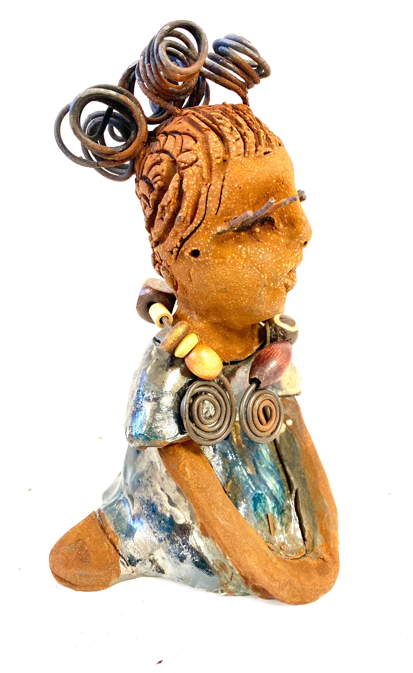 Janet stands 6" x 4" x 4" and weighs 14 ozs. Janet has a honey brown complexion with wire hair. She wears long lashes and has a alligator green metallic dress. She wears an awesome wood bead necklace. Janet has her long loving arms around her knees as she rest and waits.