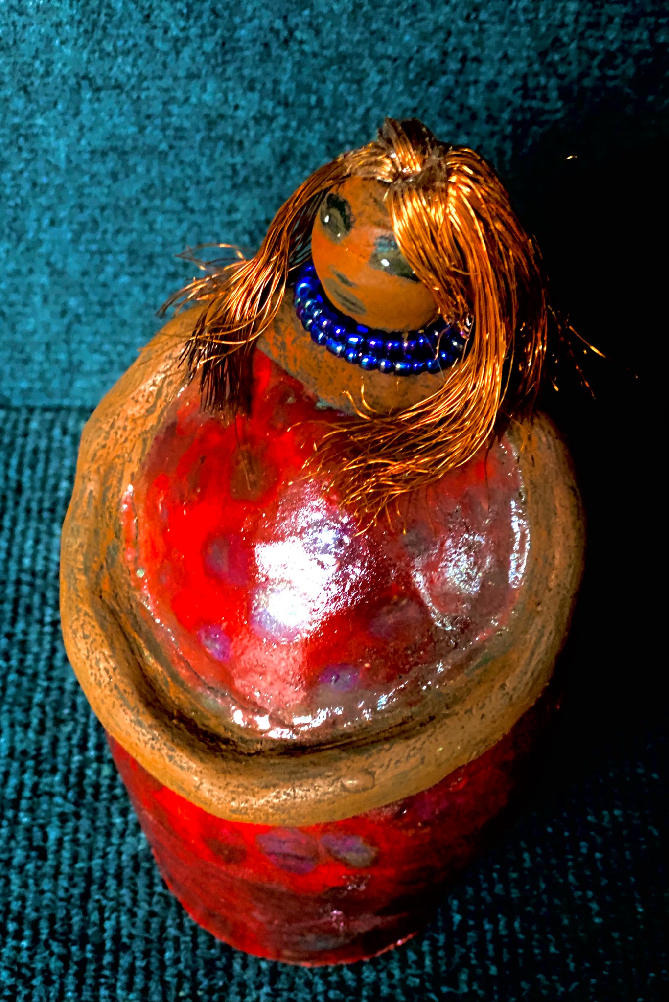 ﻿Meet Dora!  She is a big girl who loves to sing and has aspirations of becoming a  movie star.  Dora stands 7" x 4" x 4.5" and weighs  1.06 lbs.  She has a lovely honey brown complexion with lovely reddish brown lips.  Dora has a lovely gold spotted heart glazed dress.  She wears a beaded  dark blue necklace.  With eyes wide opened, Dora has hopes of finding a new home.   Dora has a twin sister name Cora.