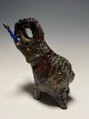 Raku Elephant Have you HERD!!!!!!  Just one of these lovely Raku Fired Elephant will make an excellent gift for your  friend, sorority or for your home’ special place centerpiece.   6" x 4" x 4" 1 lbs Beaded tusk with blue and gold wire Beautiful  colorful metallic raku elephant For decorative purposely only