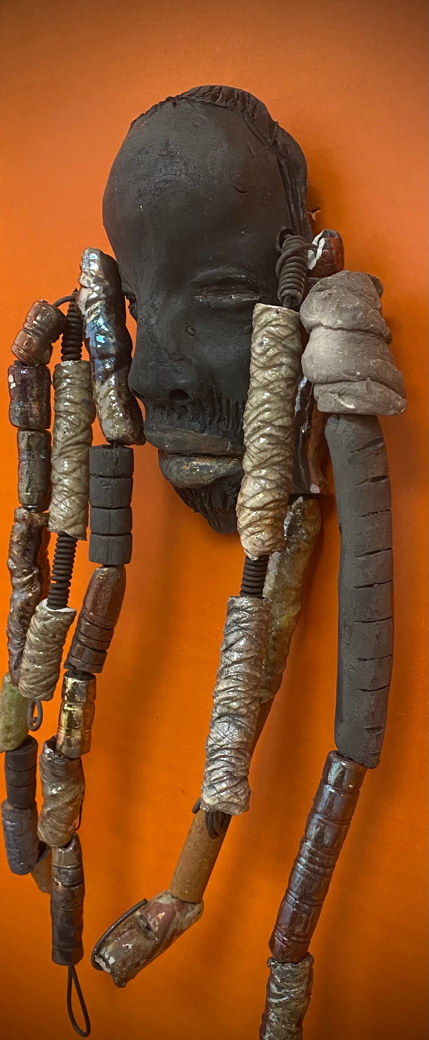 Meet Cain! You Like Wise men; You gotta Love Cain! I started making art soon after seeing authentic African artwork at the Smithsonian Museum of African Art. I was in total awe. Cole was inspired by my visit there.   Cain is a wise and distinguished  bearded gentleman who has a smoky dark complexion. He is approximately 5" x 11" and weighs 13 ozs. Cain has an aged hairstyle of more than 20 handmade textured clay dreadlocks along with twist of coiled 16 gauge wire.