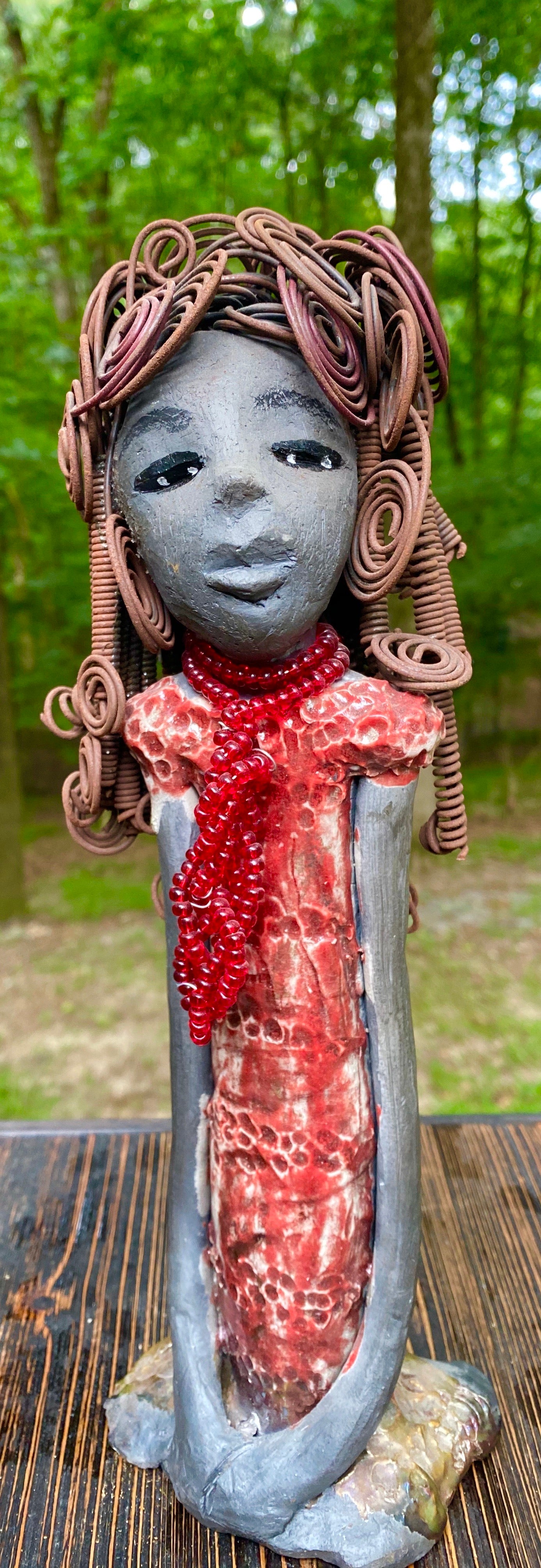 Meet Reagan! Reagan stands 12" x 4" x 4" and weighs 2.10 lbs. Reagan has a lovely dark complexion. It took over two hours to fix her Herdew! It is made of 16 gauge wire. Reagan has a shimmering  metallic copper red dress. A strand of ruby red beads hangs around her neck. Reagan and her sister Carolyn are one of a kind. ( Sold Separately) Give Reagan and Carolyn a great Home!