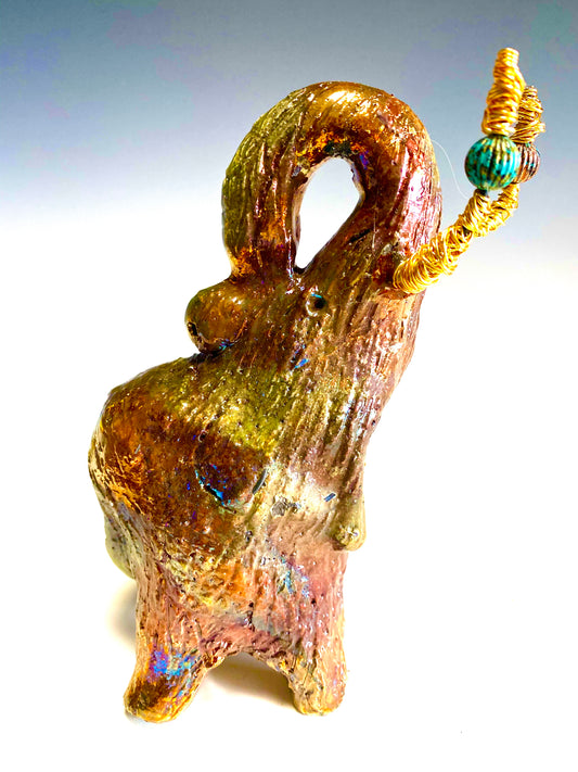 Raku Elephant Have you HERD!!!!!!  Just one of these lovely Raku Fired Elephant will make an excellent gift for your  friend, sorority or for your home’ special place centerpiece.  6" x 4" x 5" 14 ozs. Beautiful copper, green and gold metallic raku elephant  Gold beaded tusk  For decorative purposely only.