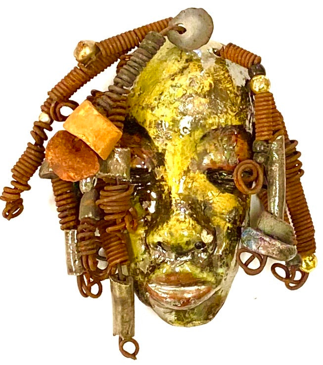 Araya has a yellow green complexion and dark red lips! She is 3”x 5”" and weighs 9 ozs. Araya  has over 5 handmade raku fired beads. She has over 20 feet of coiled 16 gauge wire hair.
