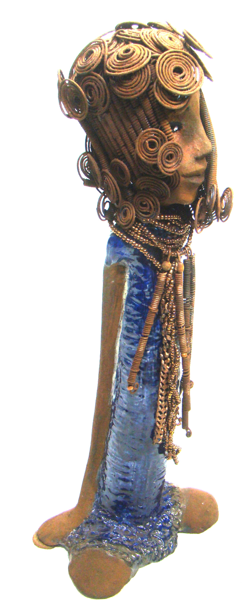      Kya stands 20" x 8" x 5" and weighs 6.04 lbs.     She has a lovely honey brown complexion.     Kya has over 40 feet of rust wire coils and spiral hair.     Her dress is a metallic blue with streaks of copper.     Her necklace is made from rust wire coils and amber beads.     Kya has long loving arms that are placed behind her.     Kya radiates like a blue diamond in the sky.     Give Kya a special place in your home!     Free Shipping!