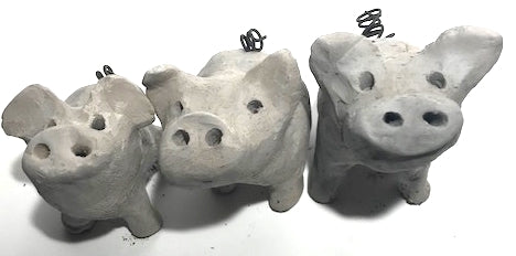 Three smokey grey raku pigs.