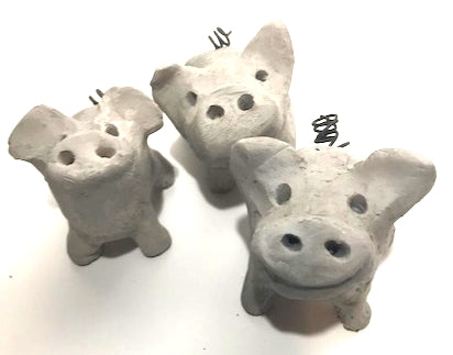 Three smokey grey raku pigs.