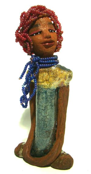 Tiffany stands 10" x 4.5" x 2" and weighs 1.05 lbs. She has a lovely honey tan complexion with purple beaded hair. Tiffany dress is glazed with blue and gold crackle. She wears a blue beaded necklace scarf.